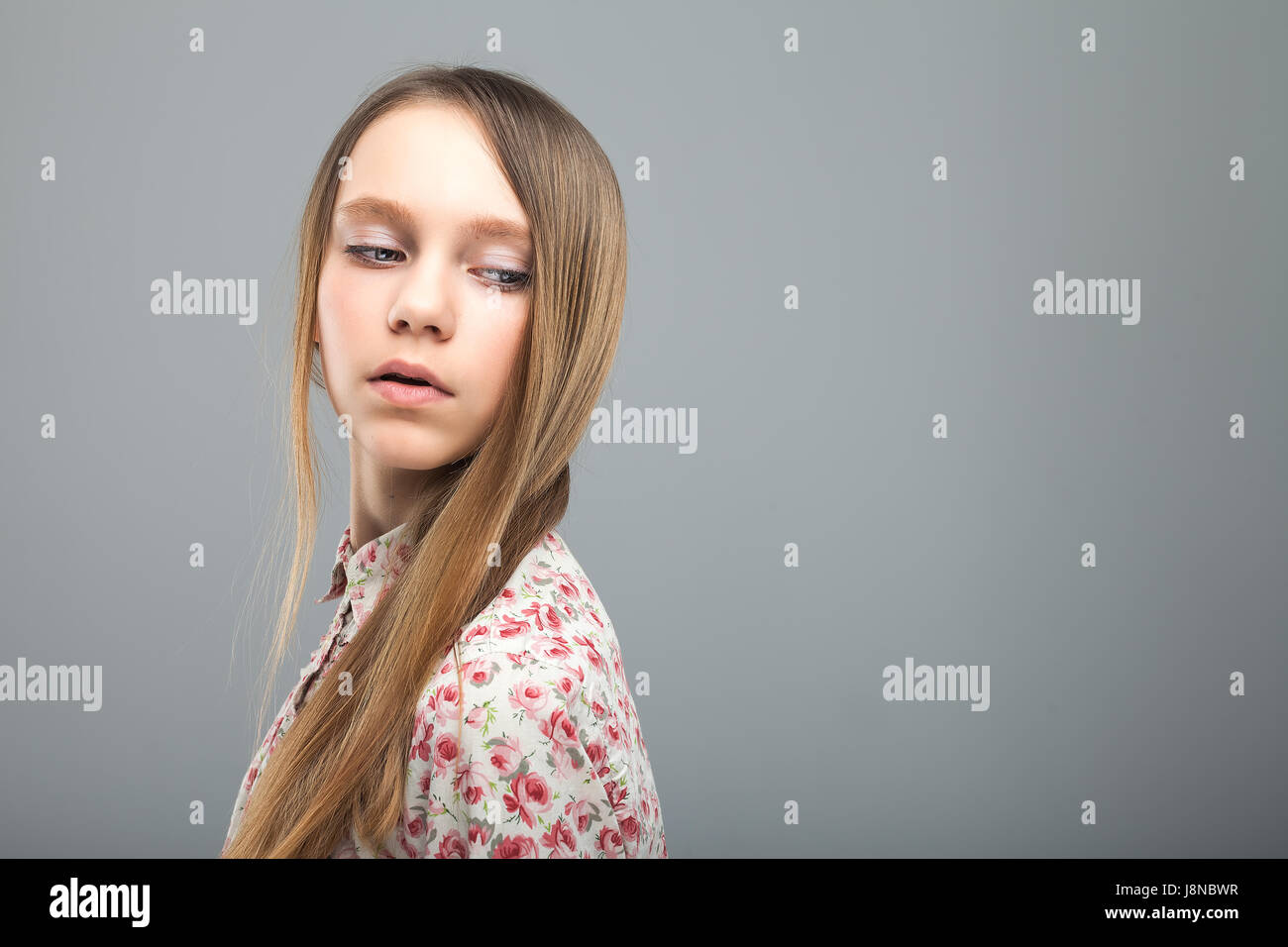 Young Beautiful Girl In Blouse With A Pattern Of Flowers Long