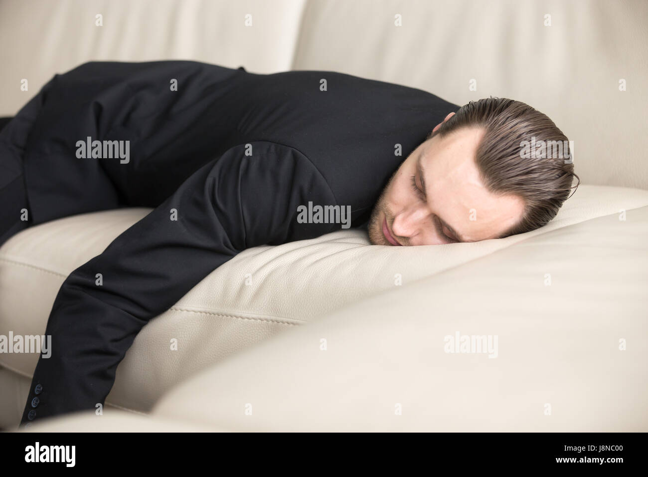 Tired businessman takes break for short sleep Stock Photo
