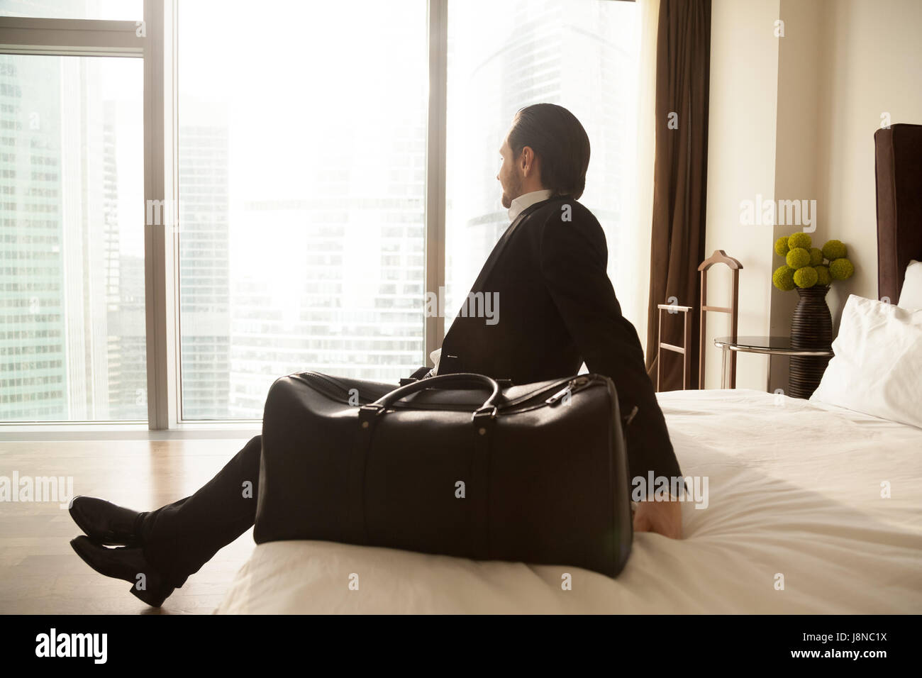 Entrepreneur resting in hotel room after flight Stock Photo
