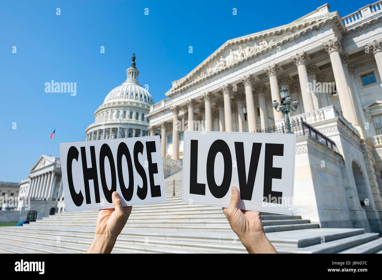 Hands of political protesters holding signs of the positive message CHOOSE LOVE in front of the Capitol Building in Washington DC, USA Stock Photo