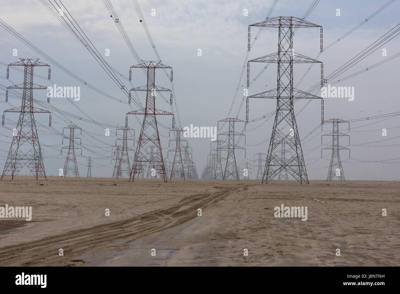 Large power lines through the desert providing the high demand for electricity in Kuwait City