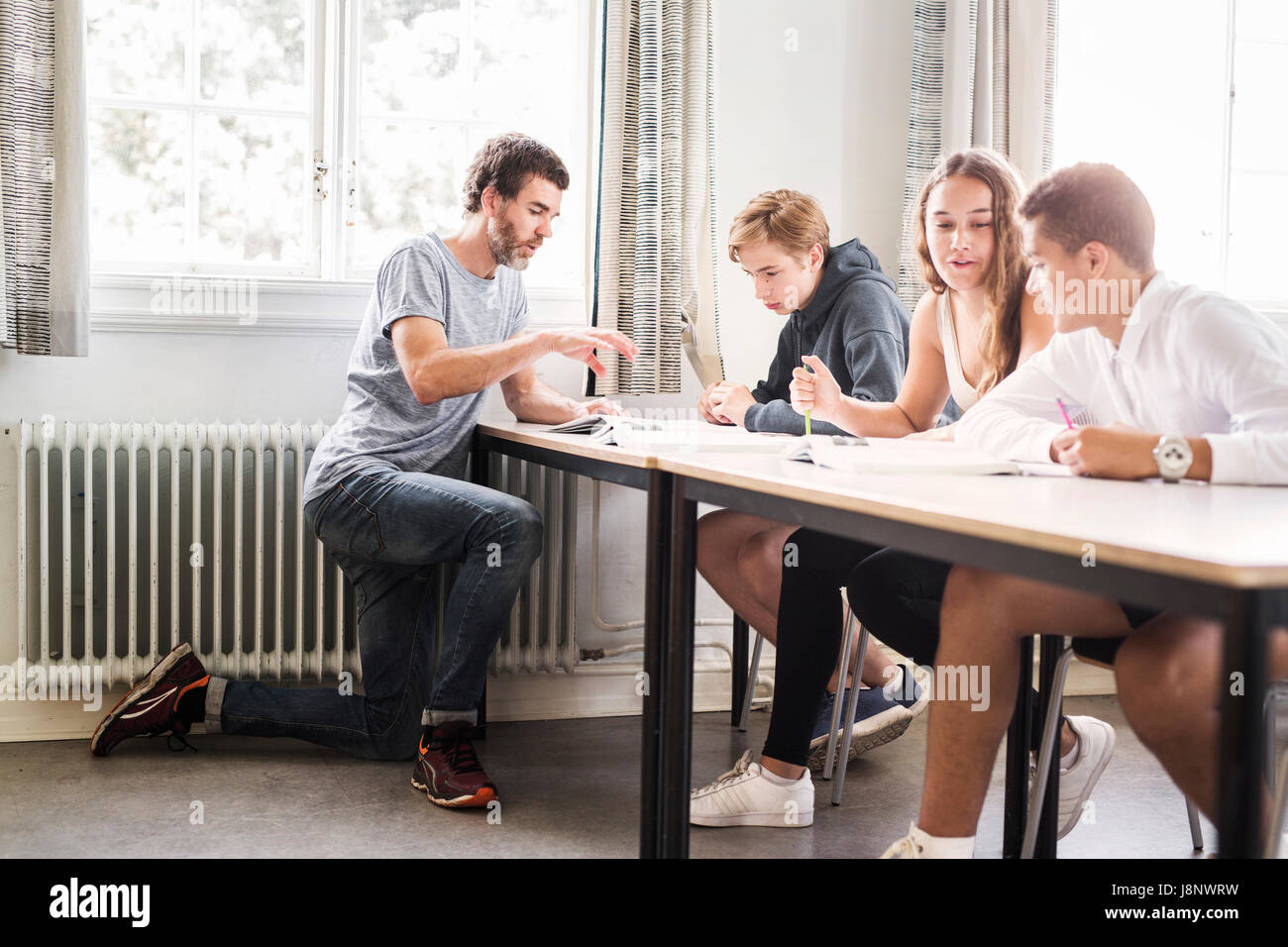 Teacher and students (14-15) in classroom Stock Photo