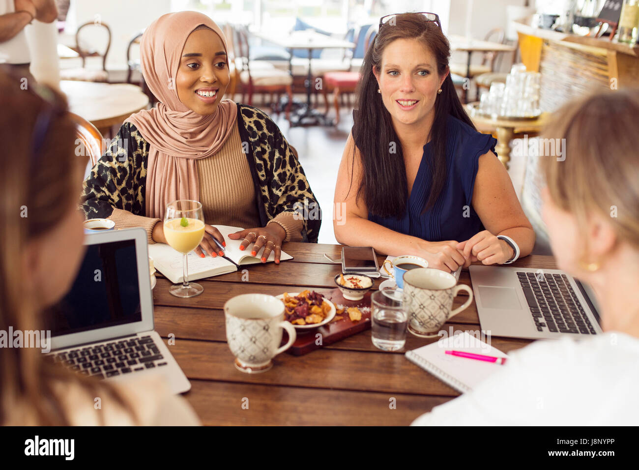 Businesswomen working during lunch in restaurant Stock Photo