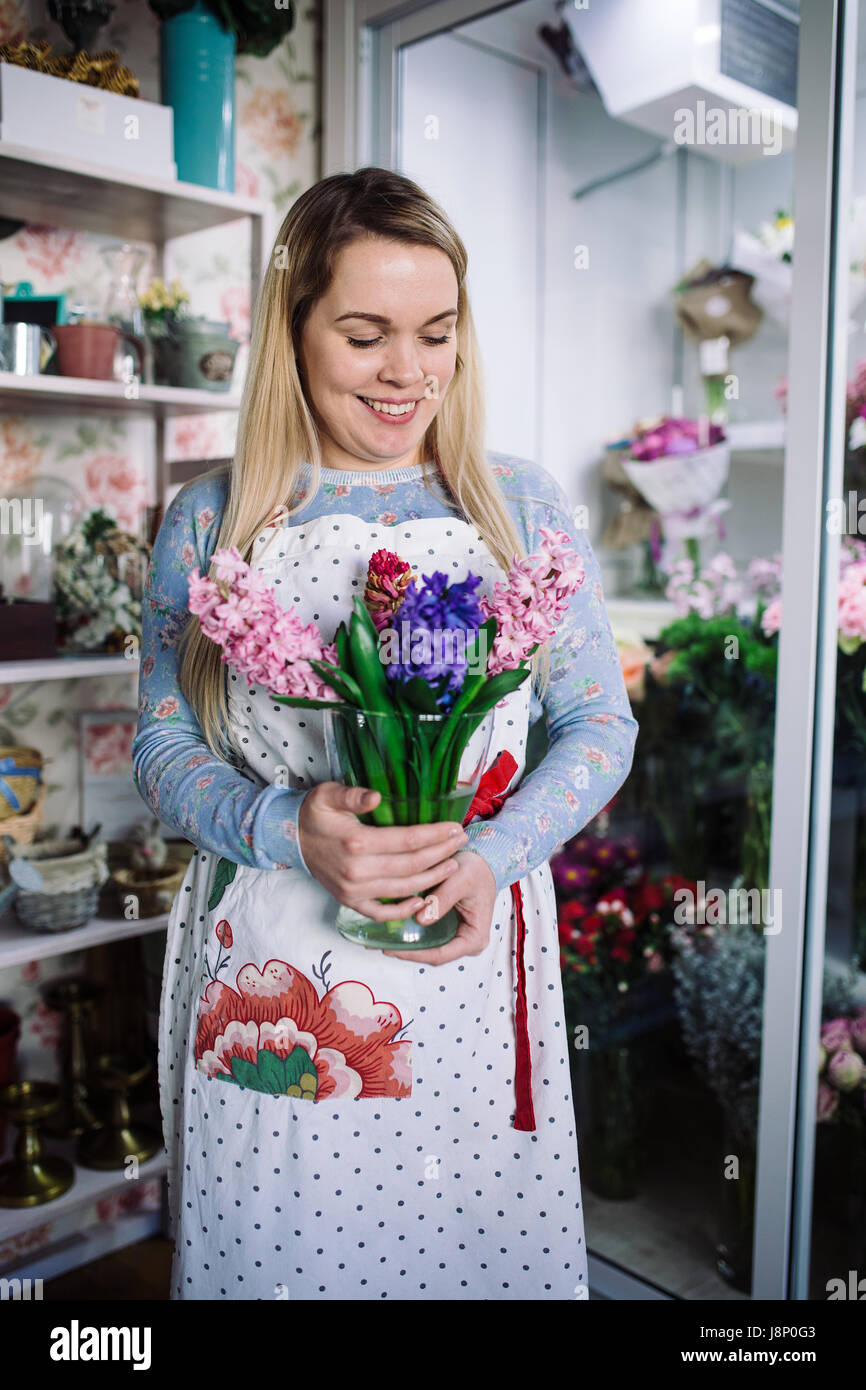 woman florist holding bouquet of hyacinth indoor in flower shop Stock Photo