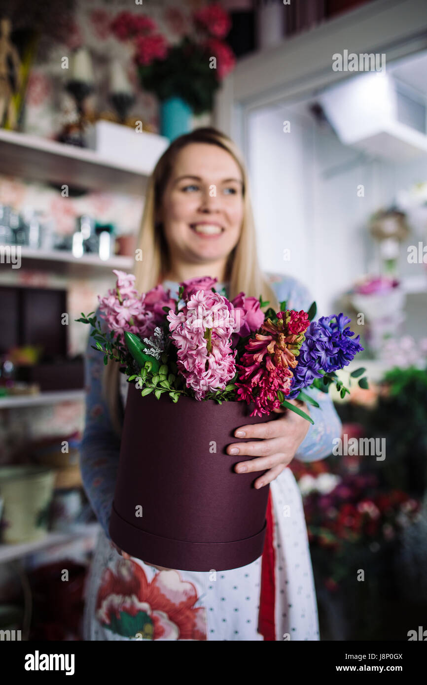 woman florist holding bouquet of hyacinth indoor in flower shop Stock ...