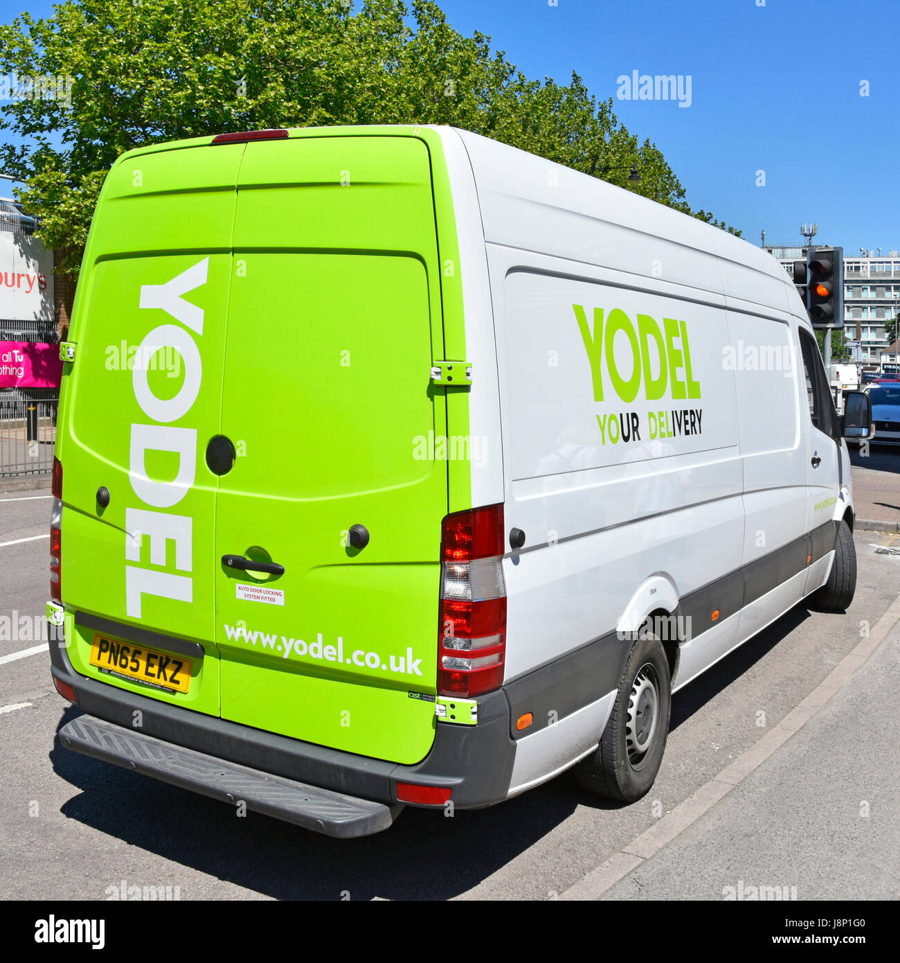 Yodel logistics  services transporting & delivery van parked behind high street shopping area part of national UK supply chain delivering process Stock Photo