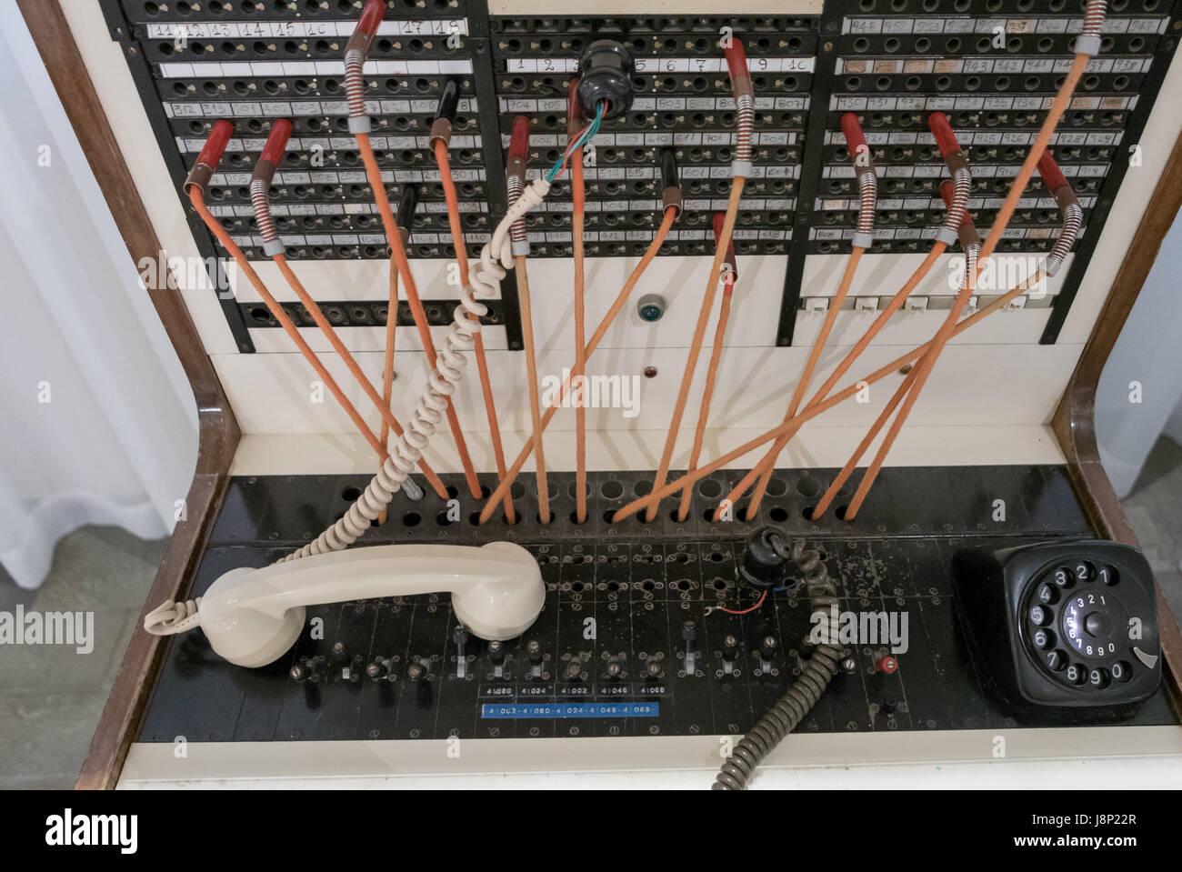 Old telephone exchange with lines and earphone. Stock Photo