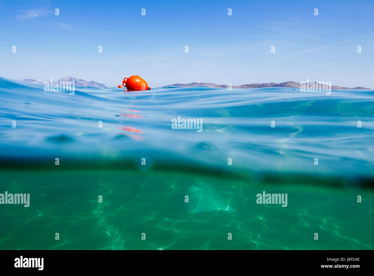 Marker buoy on surface of water. View half and half underwater Stock