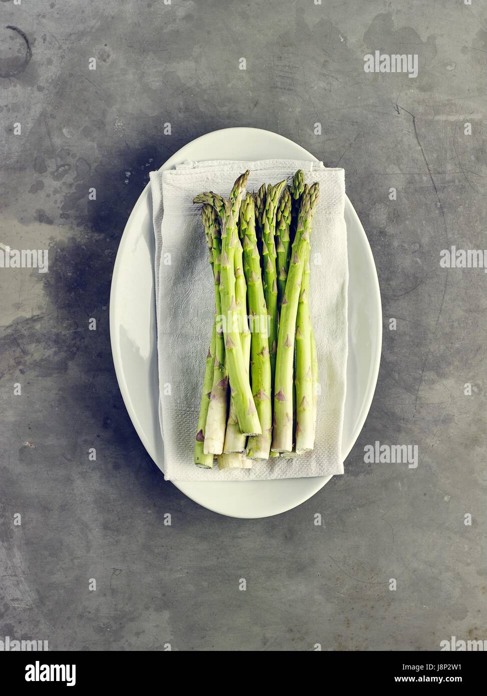 Green asparagus on oval plate Stock Photo