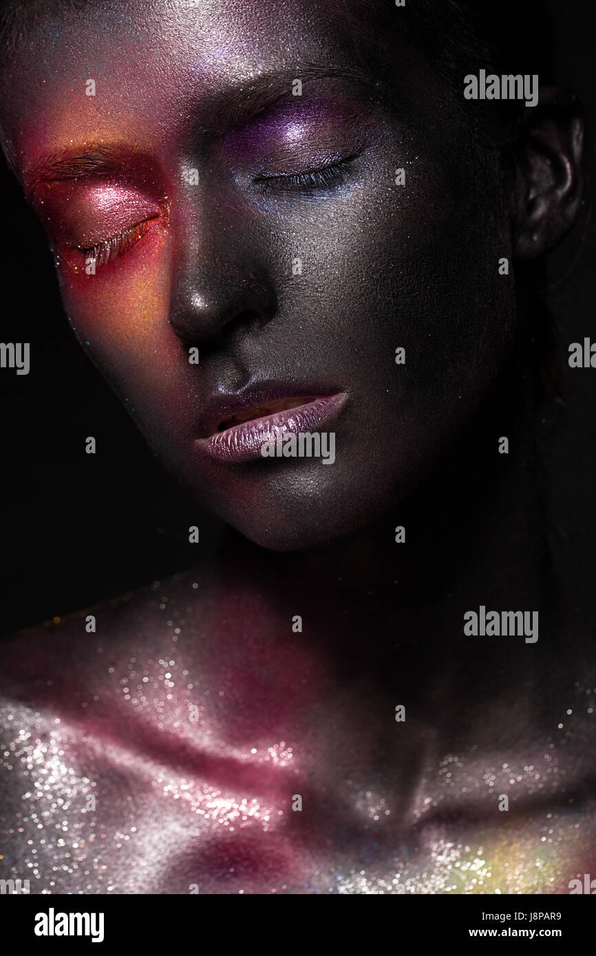Beautiful girl with art space makeup on her face and body. Glitter Face. Stock Photo