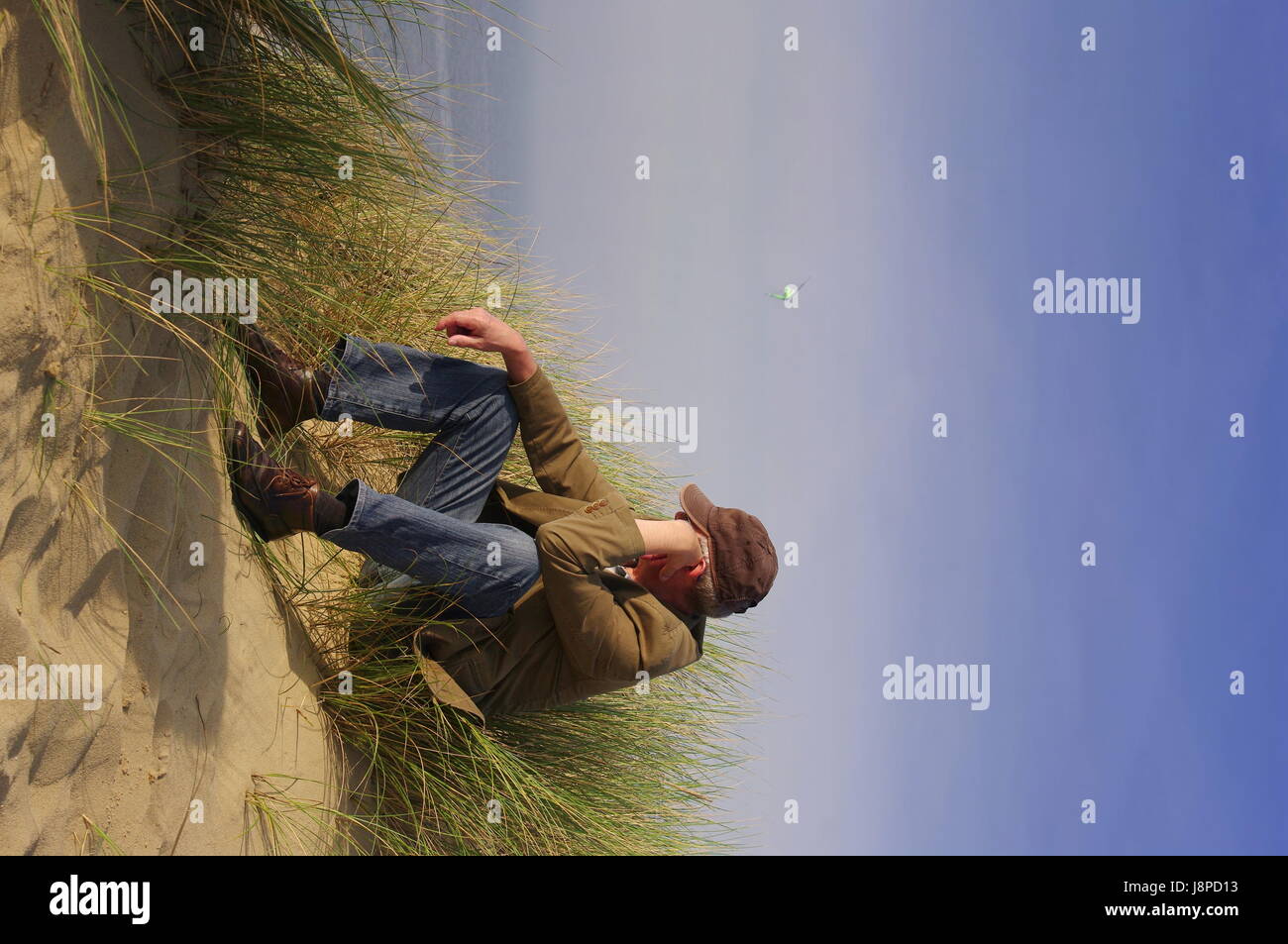 man sitting in the dunes on sylt Stock Photo