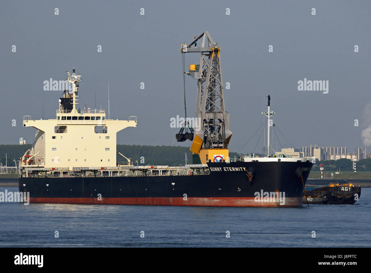 The bulk cargo vessel Sunny Eternity is unloaded on the Westerschelde at Terneuzen. Stock Photo