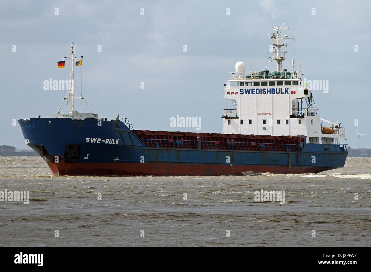 The freighter SWE-Bulk moves the Ems to go to Papenburg. Stock Photo