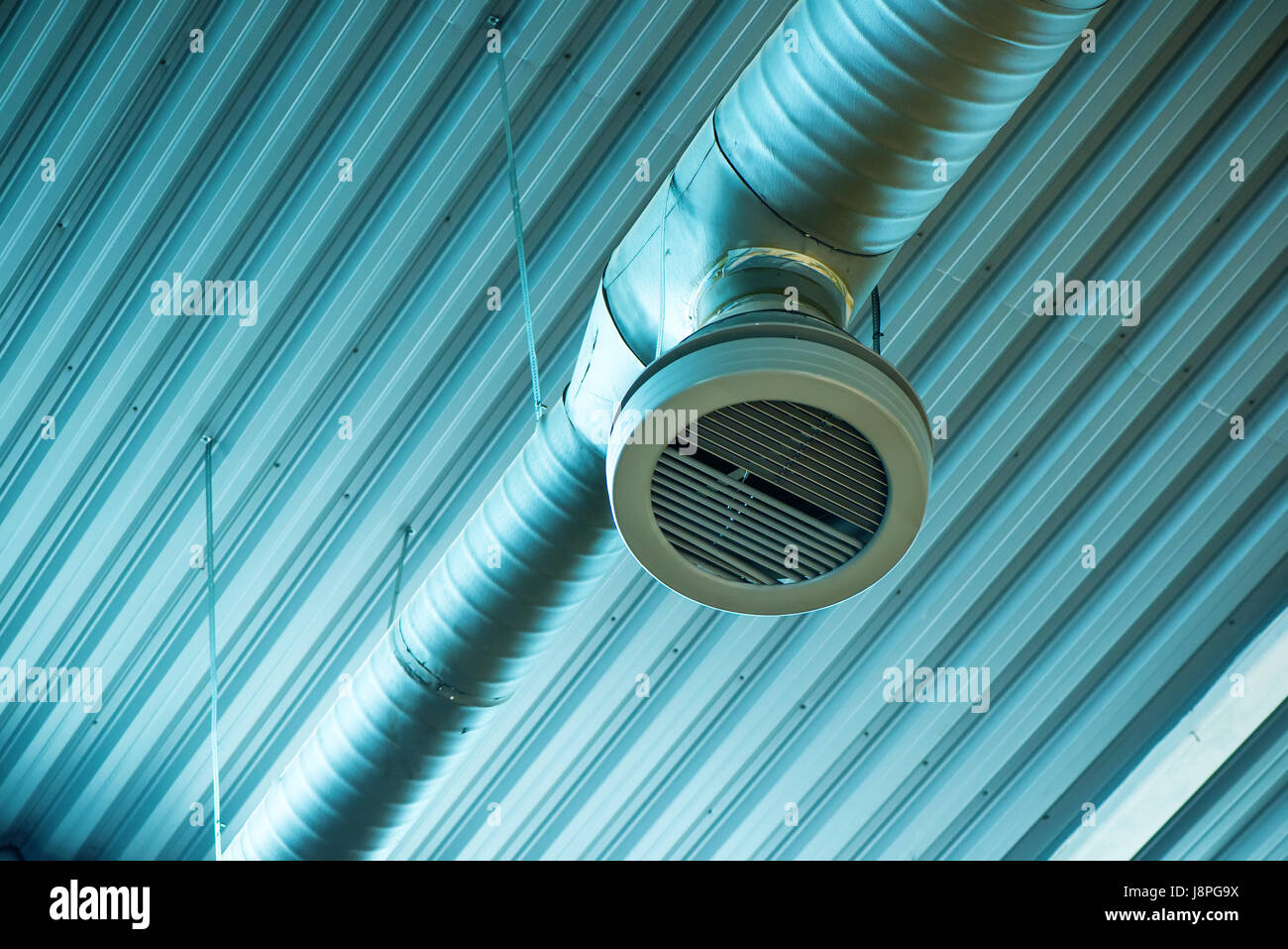Industrial ventilation system pipes on warehouse ceiling Stock Photo