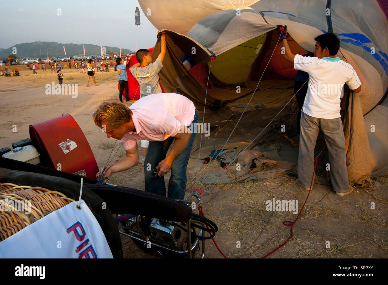 Pilot inflate cold air the balloon before fly in hot air Thailand International Balloon Festival 2009 Stock Photo