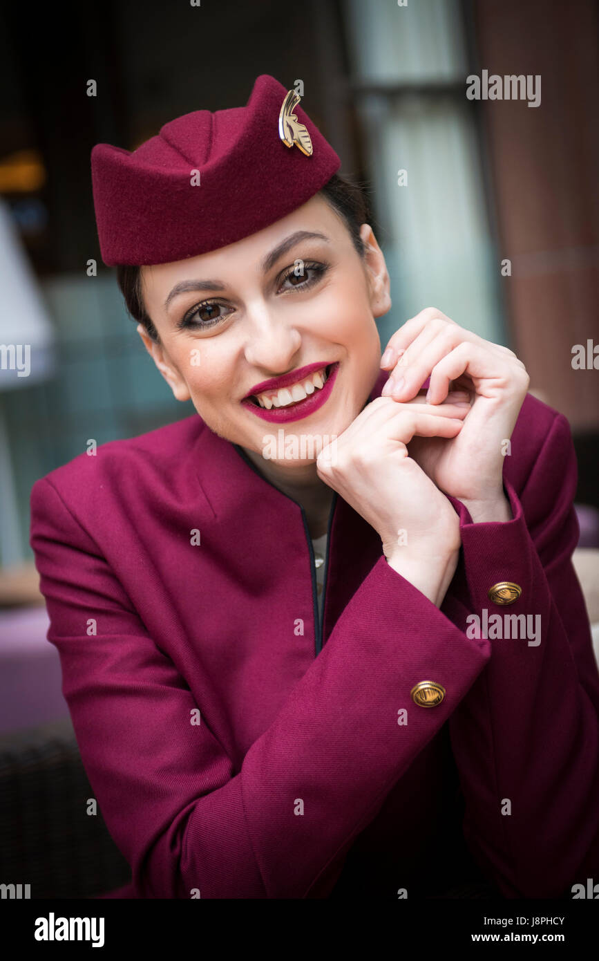 Attractive lady, Qatar flight attendant cabin crew on layover at London Heathrow Airport on next flight to Doha Qatar. Stock Photo