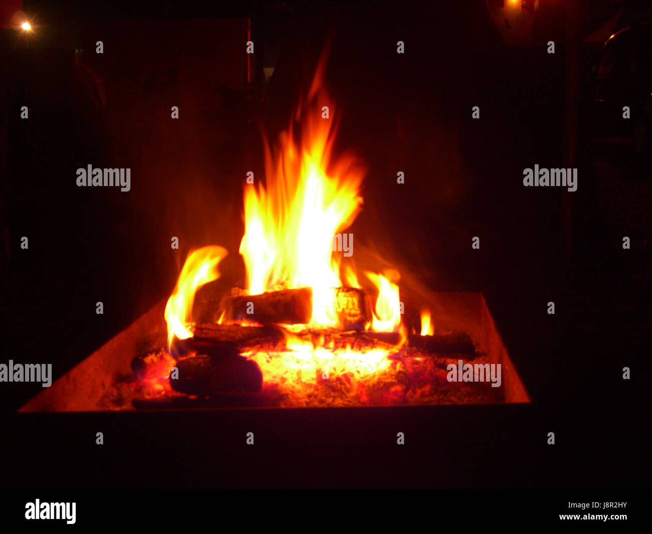 Burning wooden log flame on fire in fireplace Stock Photo Alamy