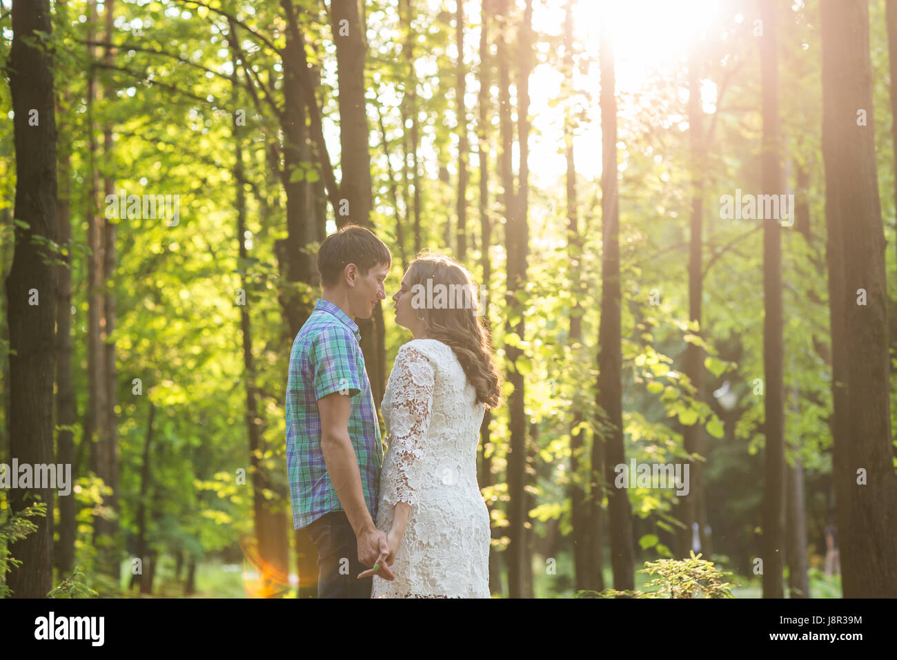 Portrait of a young romantic couple embracing each other on nature ...