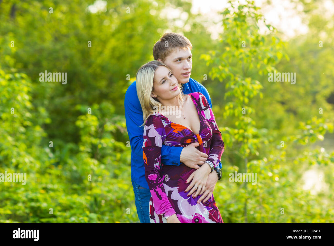 beautiful young couple hugging in the park Stock Photo - Alamy