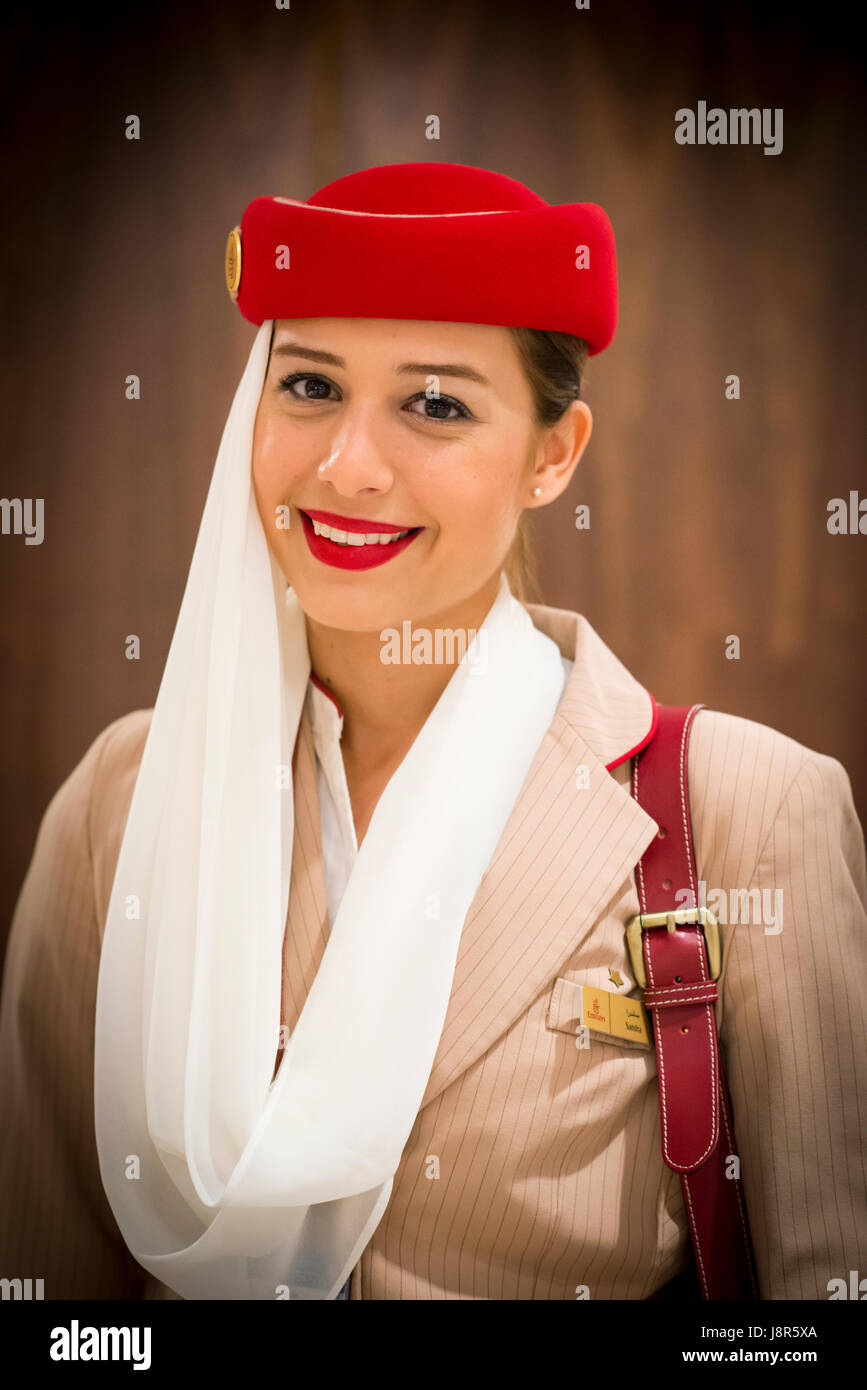 Young attractive Emirates cabin crew and flight attendant at London Heathrow Airport awaiting