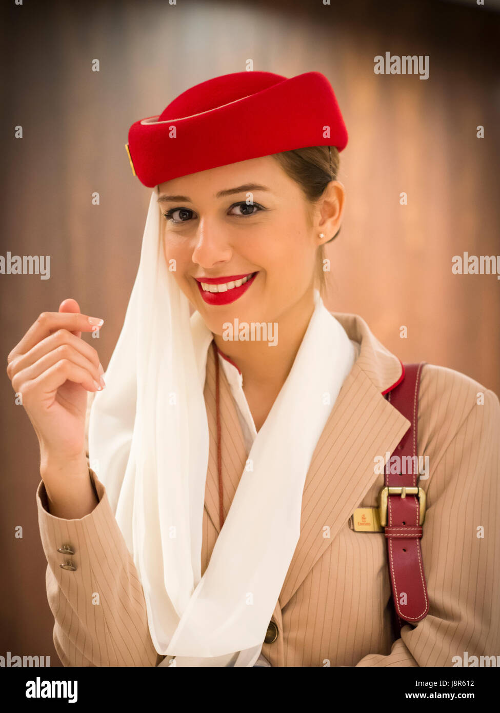 Young attractive Emirates cabin crew and flight attendant at London Heathrow Airport awaiting Emirates Airline A380 flight to Dubai Stock Photo