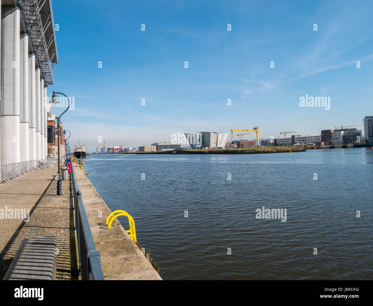 Titanic Building viewed from the area of Clarendon Dock. One of the giant Harland and Wolff cranes can be seen to the right of the building Stock Photo