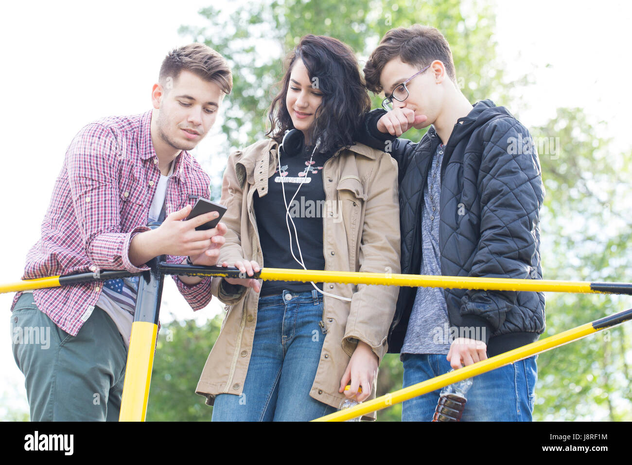 Two teenage boys talking with girl hi-res stock photography and images -  Alamy