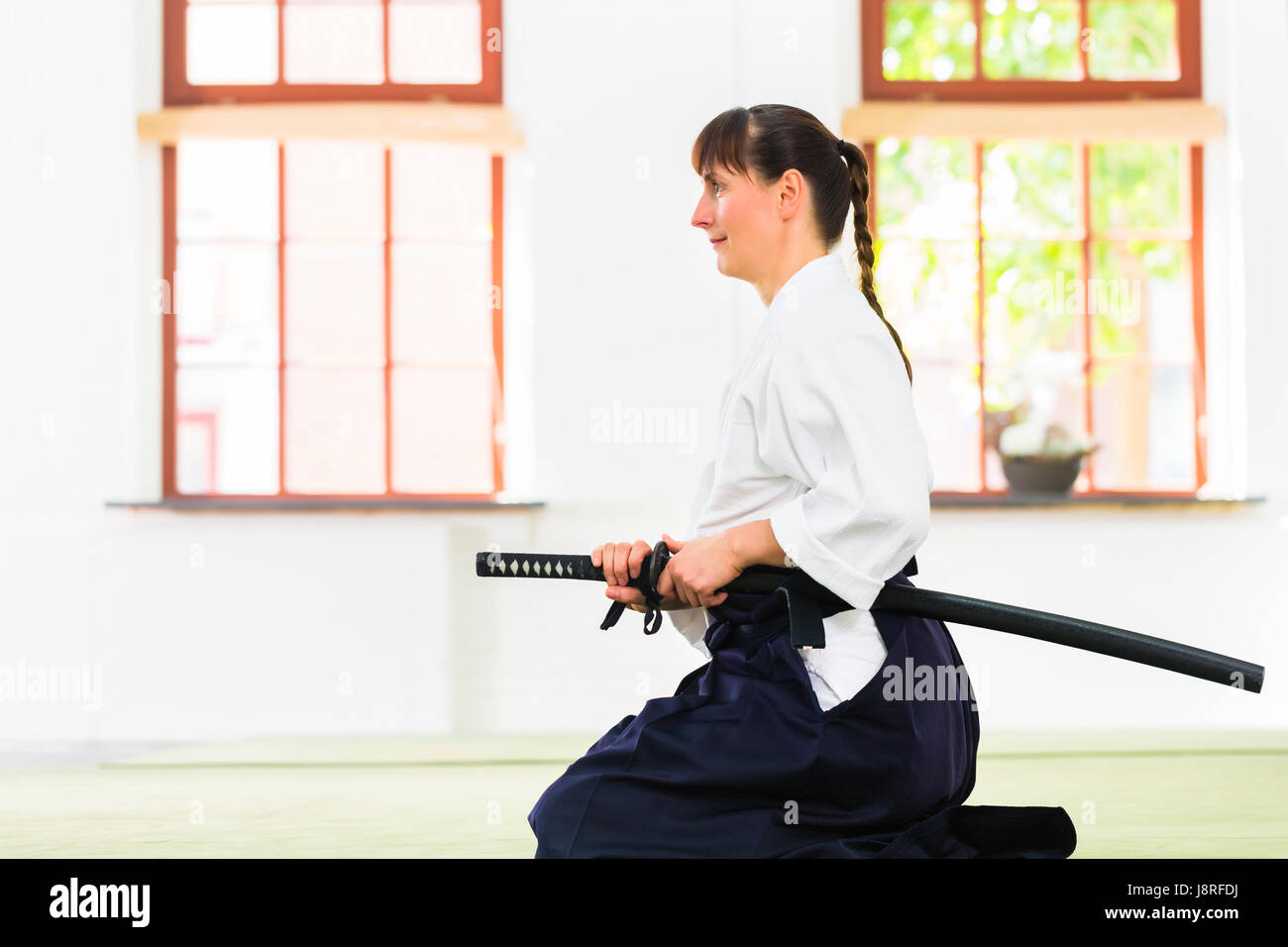 Woman at Aikido martial arts with sword Stock Photo