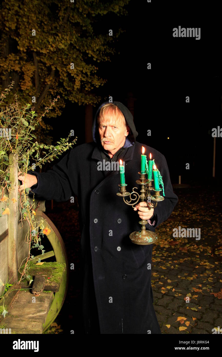 monk with candle holders Stock Photo