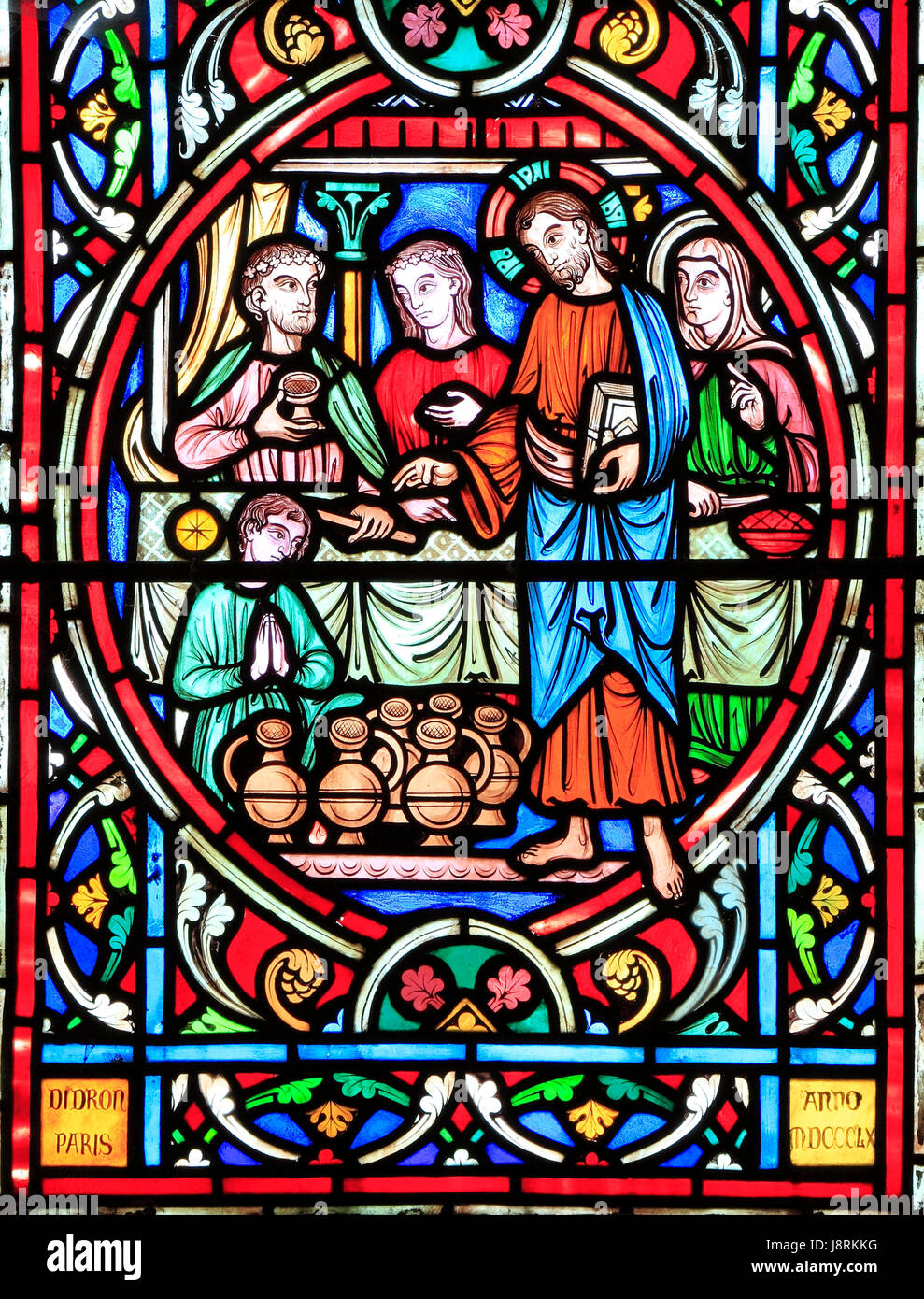 Scene from Life of Jesus, by Adolph Didron, Paris, 1860, stained glass window, Feltwell, Norfolk. Jesus at Cana Wedding Feast, turns water into wine.  Stock Photo