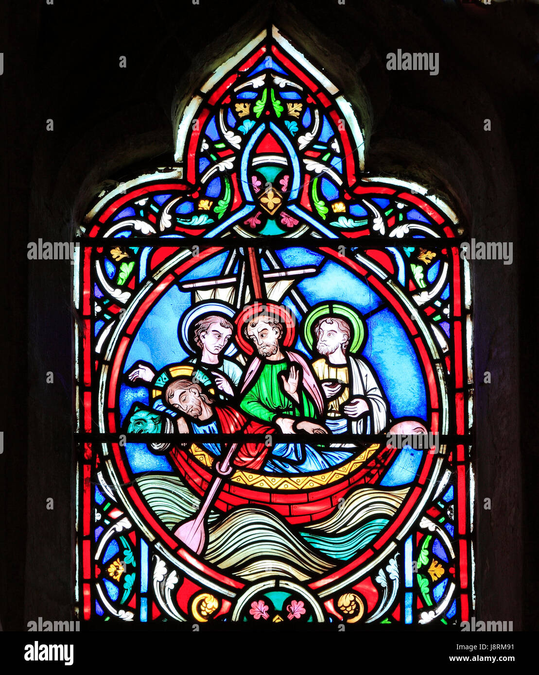 Scene from Life of Jesus, by Adolph Didron, Paris, 1860, stained glass window, Feltwell, Norfolk. Jesus sleeps in boat before storm Stock Photo
