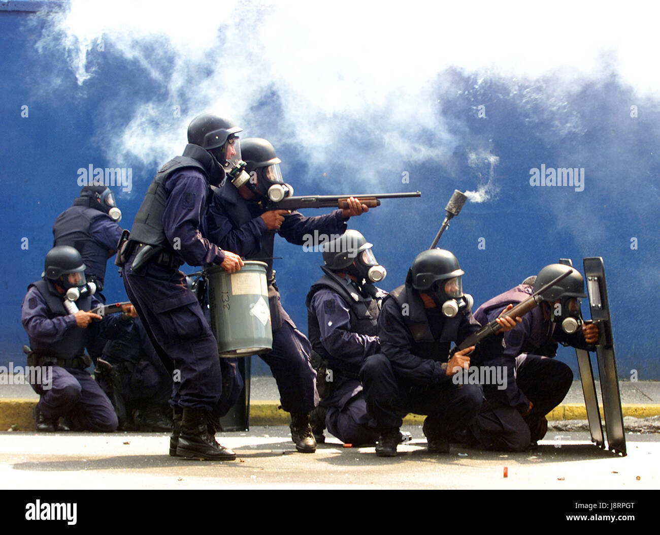 Police fire tear gas and rubber bullets at supporters of Venezuelan President Hugo Chavez in Caracas, November 4, 2002. Stock Photo