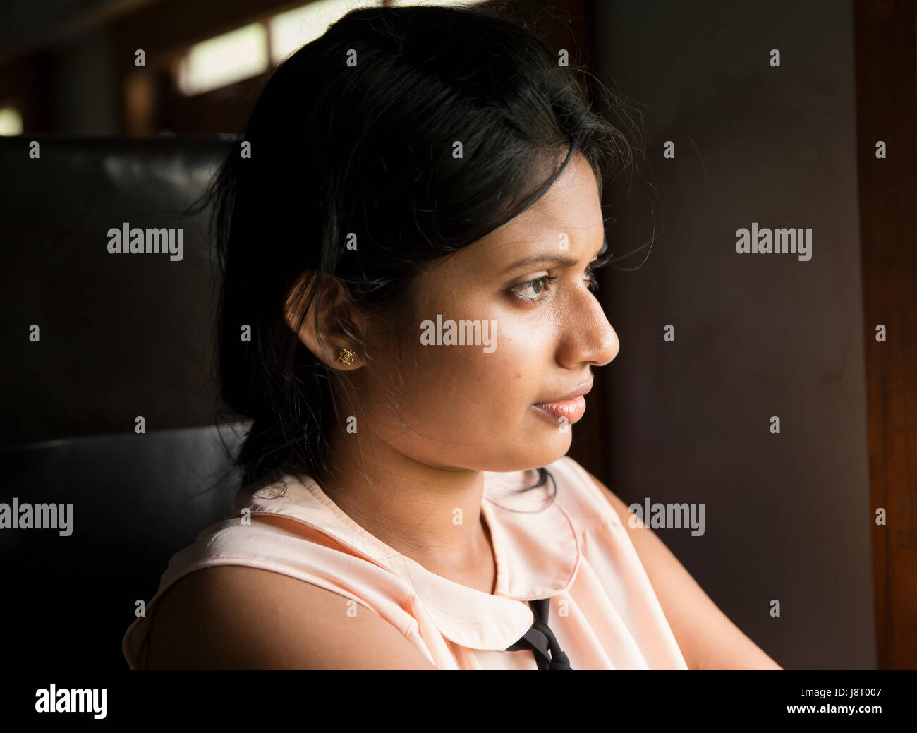 Portrait of Sri Lankan woman riding a train from the capital Colombo to the ancient city and UNESCO World Heritage Site of Anuradhapura. Stock Photo