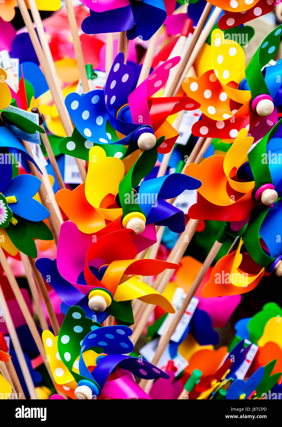 Colourful plastic windmills on sale at open air market Stock Photo