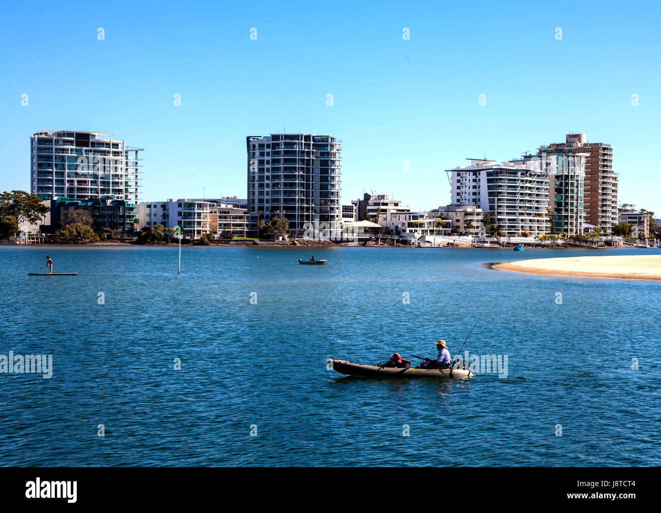 Couple enjoy a peaceful afternoon fishing in sea at Maroochydore in  Queensland Stock Photo