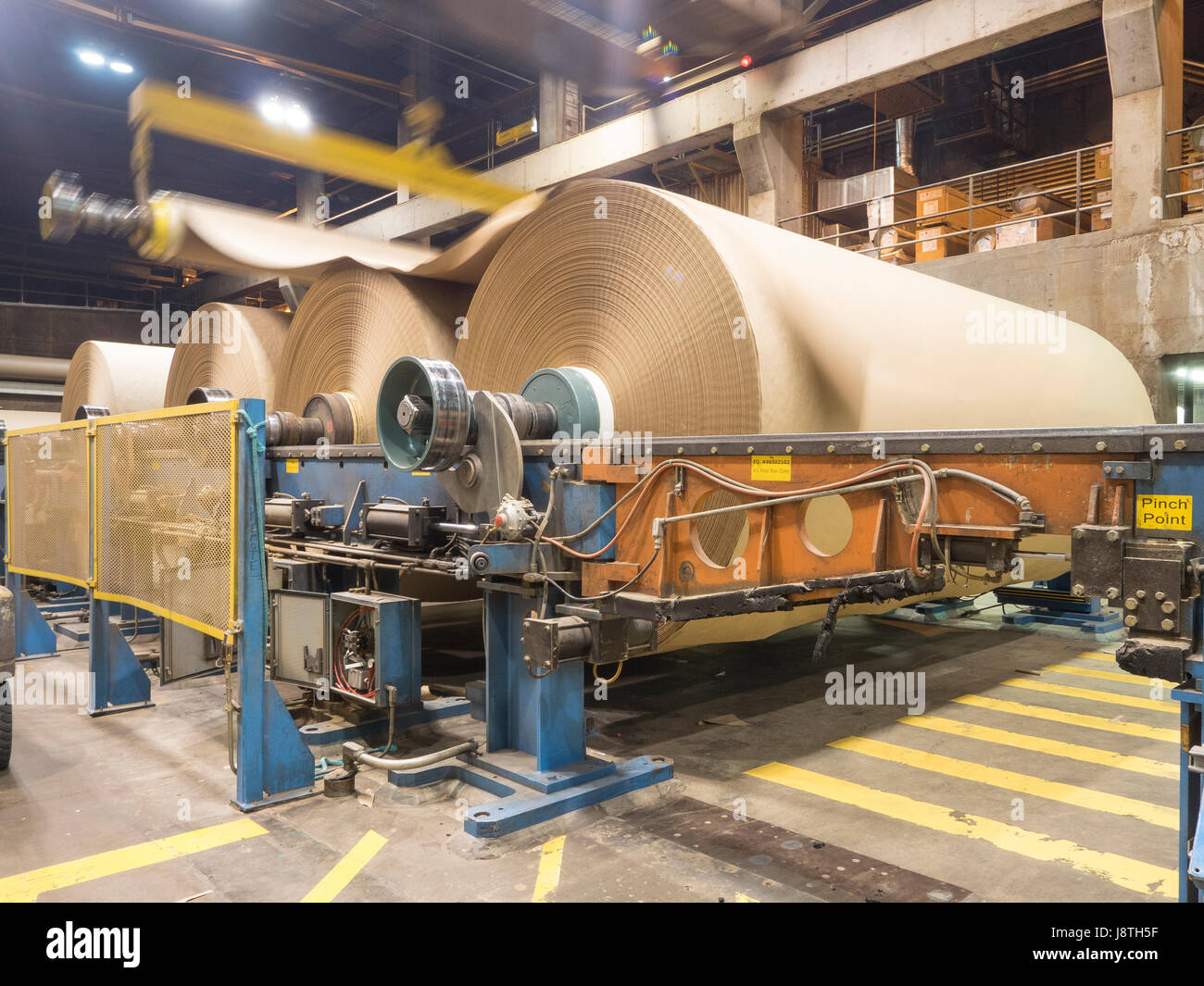 Paper mill operations in the American Pacific North West. thirty ton rolls of brown kraft paper are produced. Stock Photo