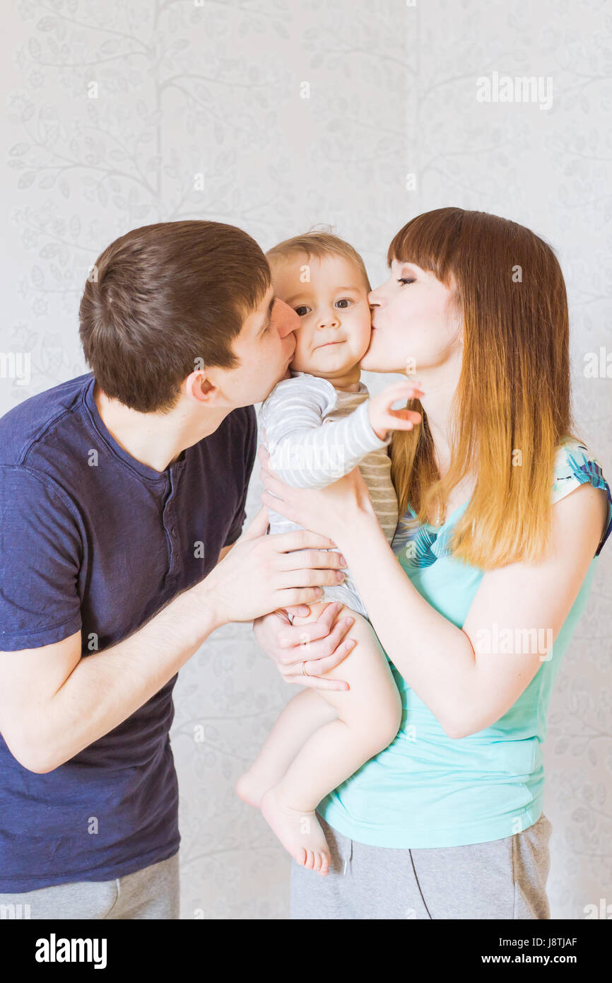 Young happy parents kissing baby boy Stock Photo Alamy