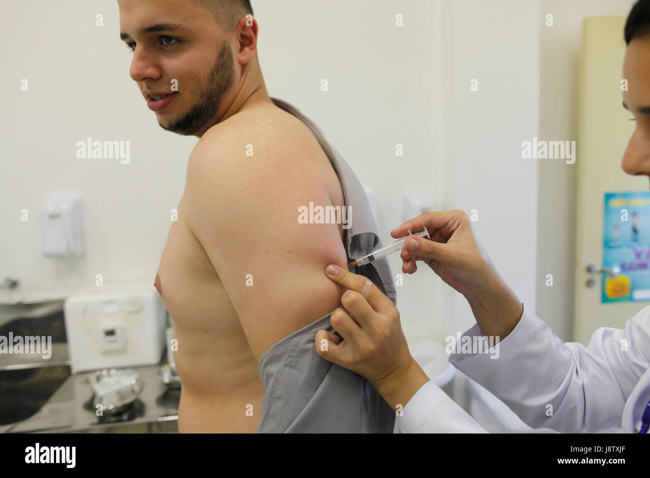 A brazilian being  vaccinated against yellow fever in a public health office at Sao Paulo city - Brazil. He would travel to Colombia next day. Stock Photo