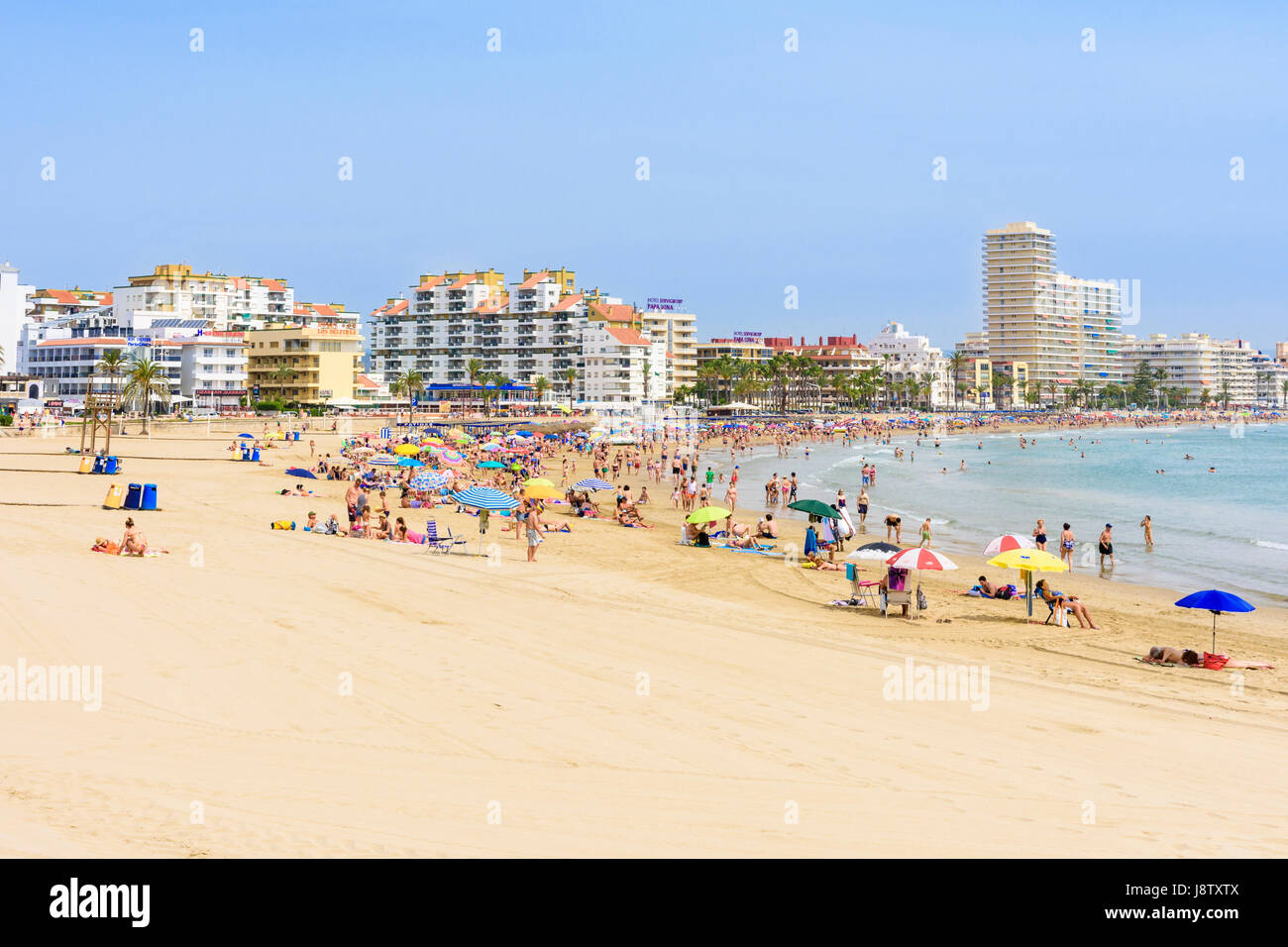 Crowded beach scene on the popular soft sand of Playa Norte, Peniscola, Spain Stock Photo