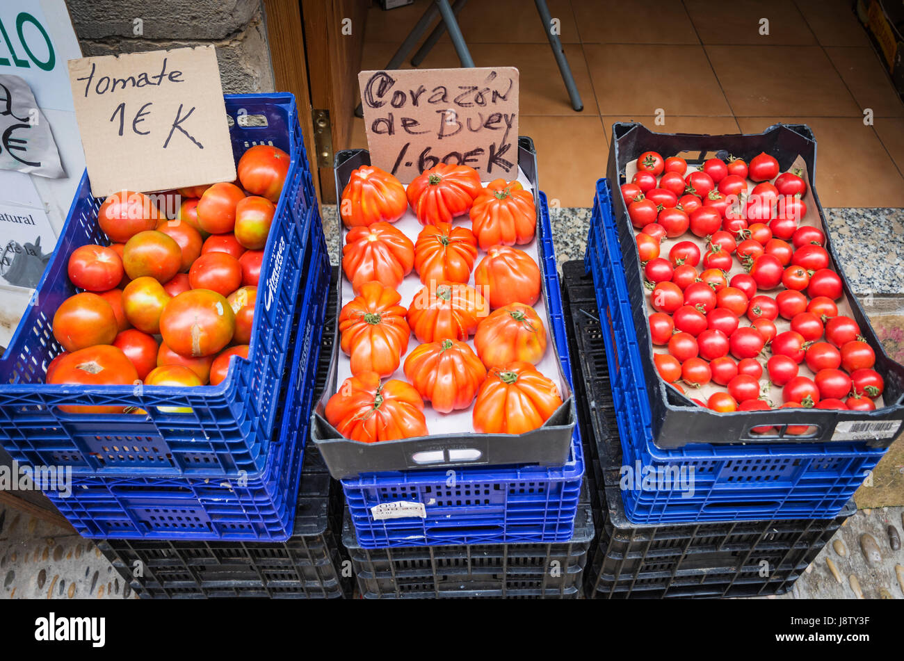 Display crates of tomato varieties outside a shop in Peniscola, Spain Stock Photo