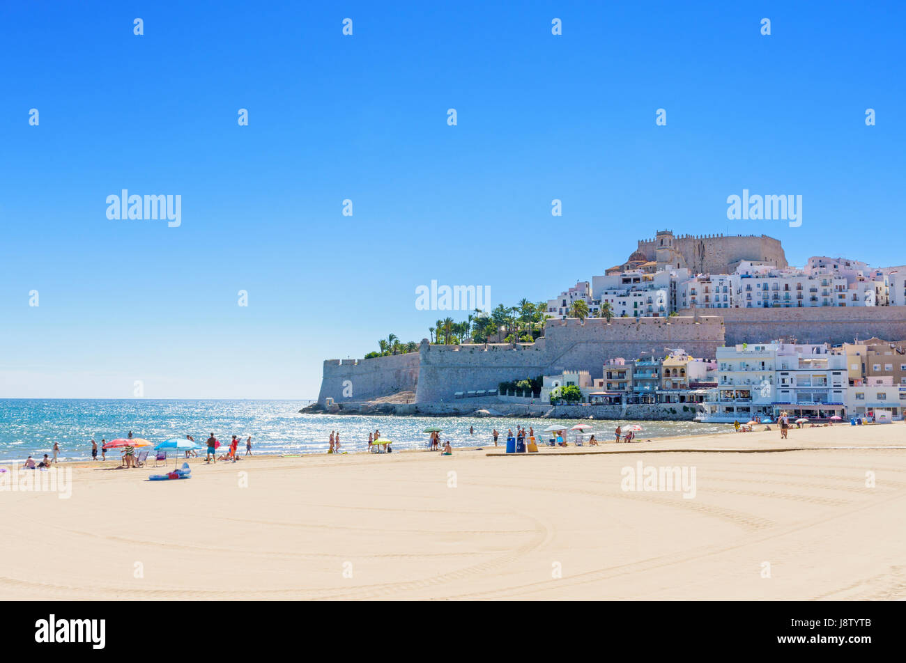 Peniscola's Papa Luna Castle and old town overlooking people enjoying the sea, sand and sun on Playa Norte beach, Peniscola, Spain Stock Photo