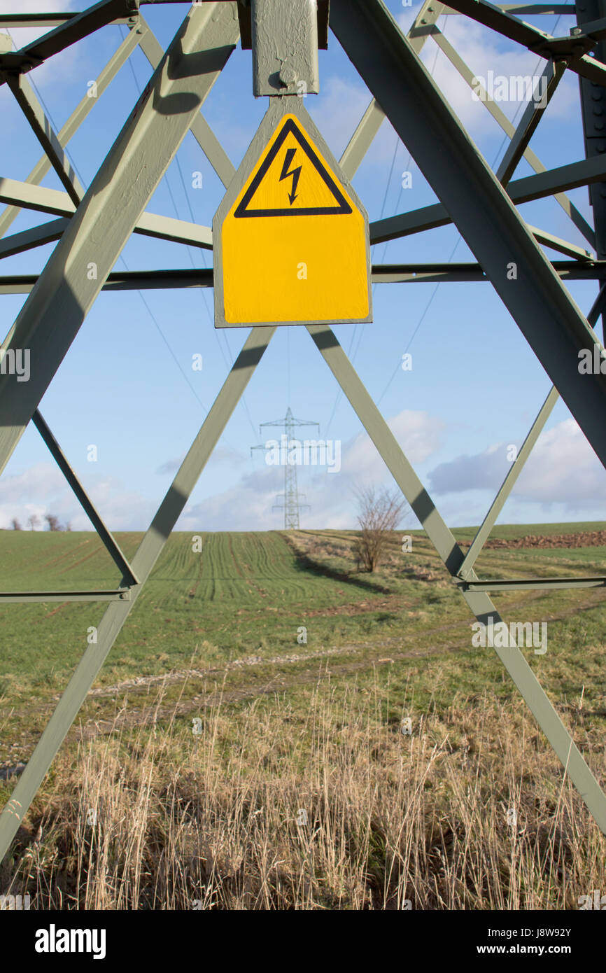 electricity pylons with sign Stock Photo