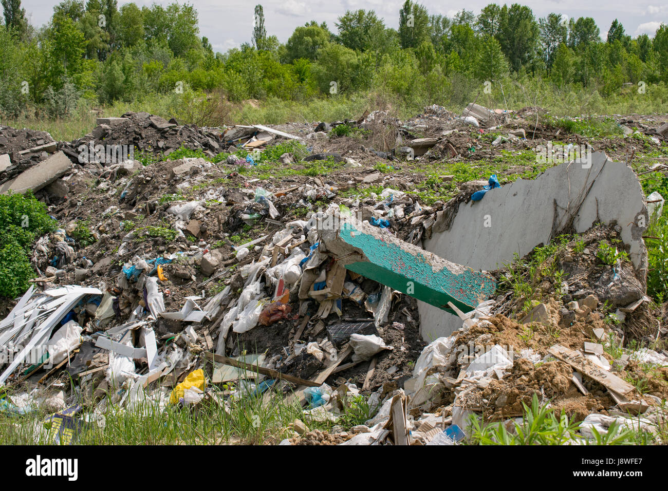 Illegal garbage dumping outside near the forest Stock Photo