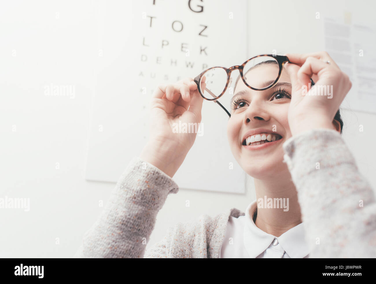 Happy young woman trying her new glasses, eye care concept Stock Photo