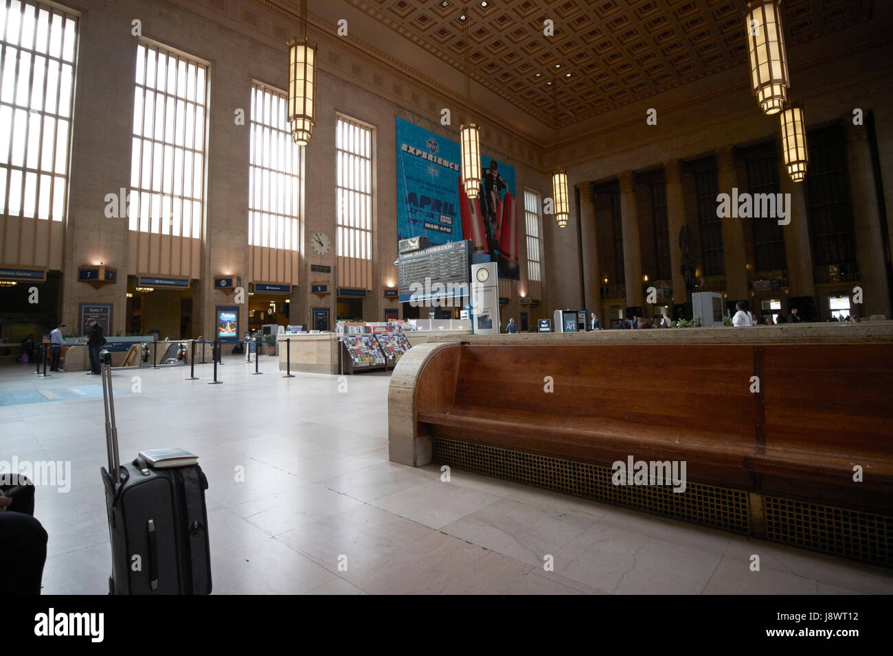 long wooden benches in main waiting room inside septa 30th street train station Philadelphia USA Stock Photo