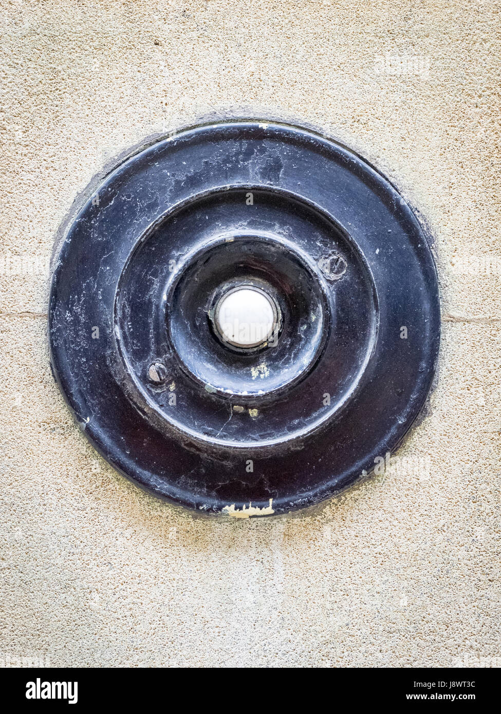 An old fashioned door bell on a building in Cambridge UK Stock Photo