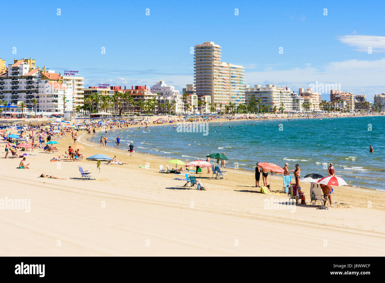 Crowded beach scene on popular soft sand of Playa Norte, Peniscola, Spain Stock Photo