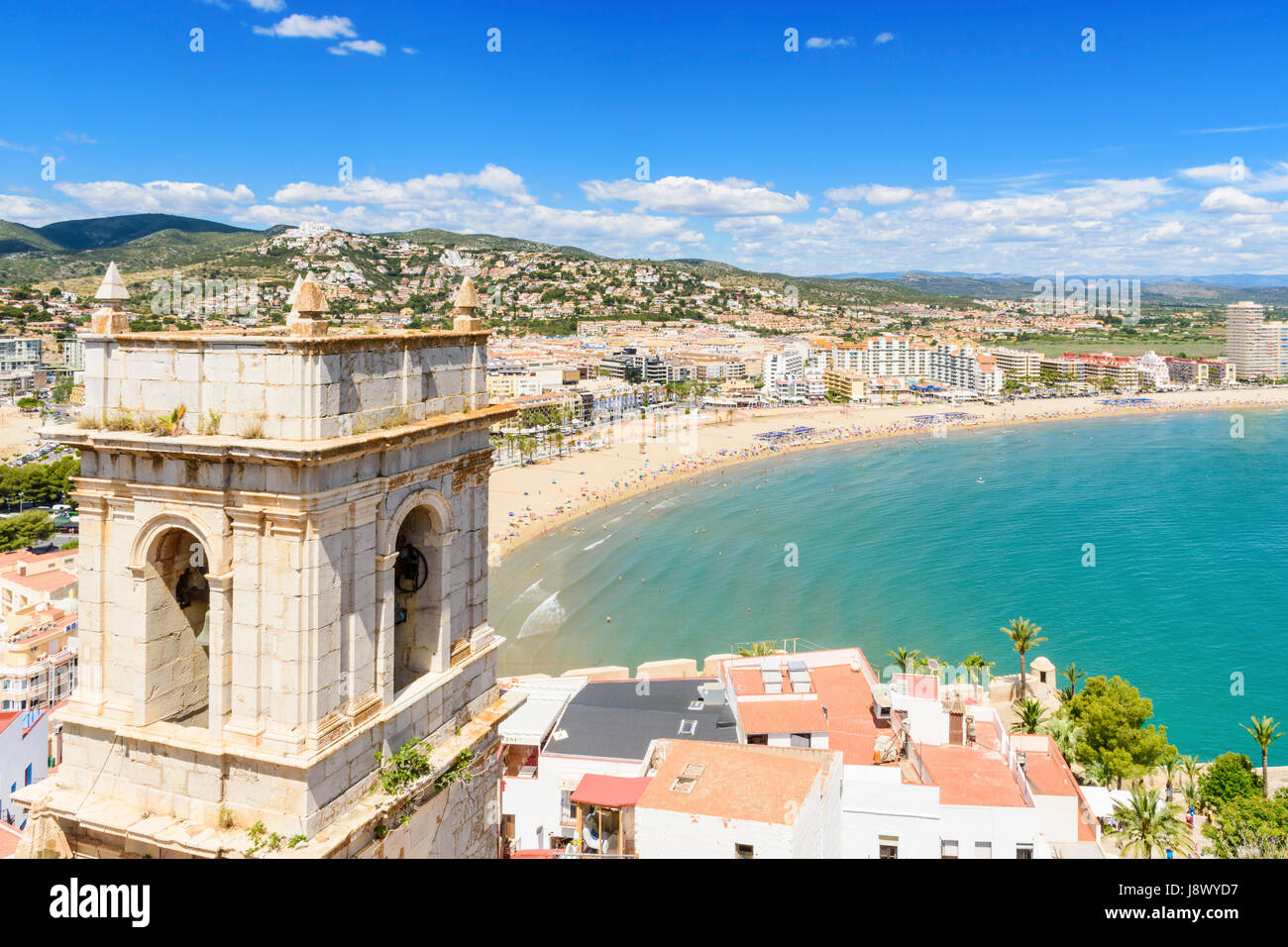 Peniscola views over the Hermitage of Our Lady of the Ermitana bell tower and old town towards beach side hotels of Playa Norte, Peniscola, Spain Stock Photo