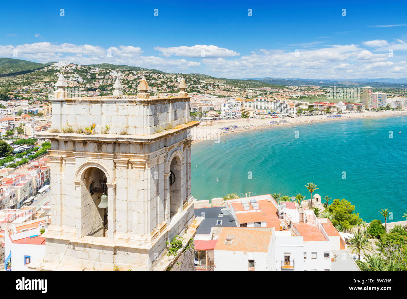 Views over the Hermitage of Our Lady of the Ermitana bell tower, and old town towards waterfront beach side hotels of Playa Norte, Peniscola, Spain Stock Photo