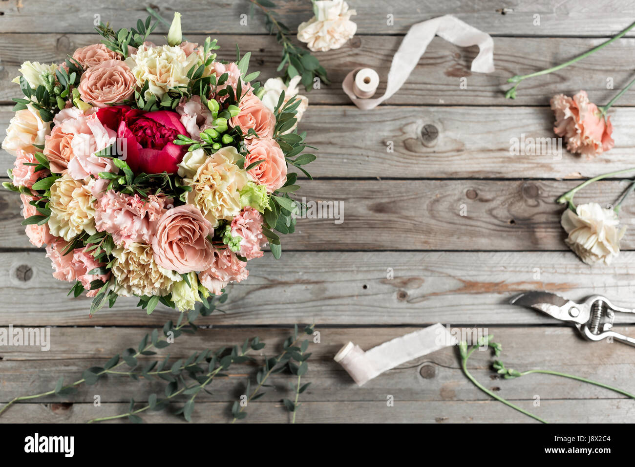 The florist desktop with working tools on gray old wooden background Stock Photo